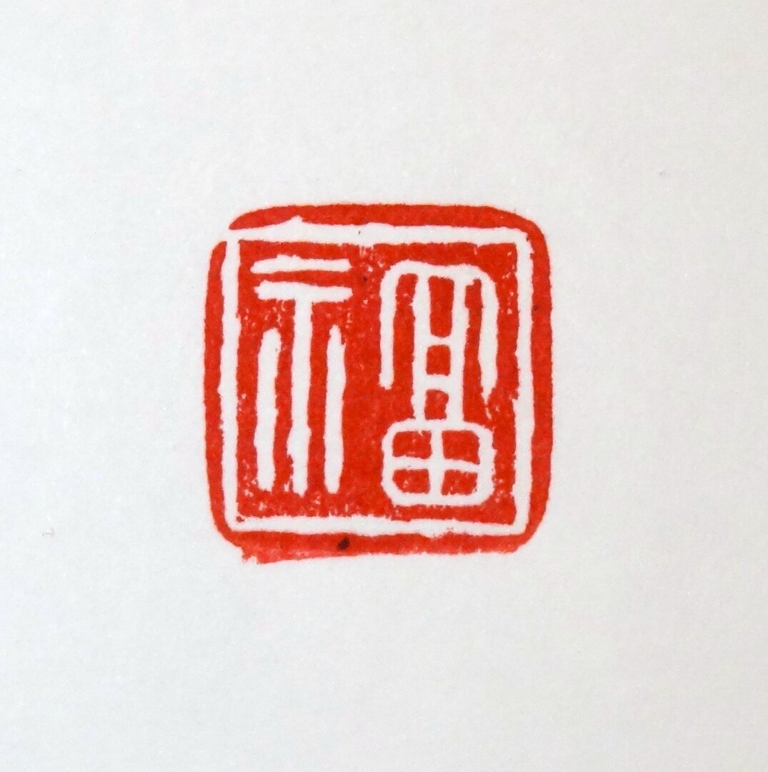 un sceau rouge, sur fond blanc, composé de deux éléments, il représente un trépied à gauche, une amphore à droite